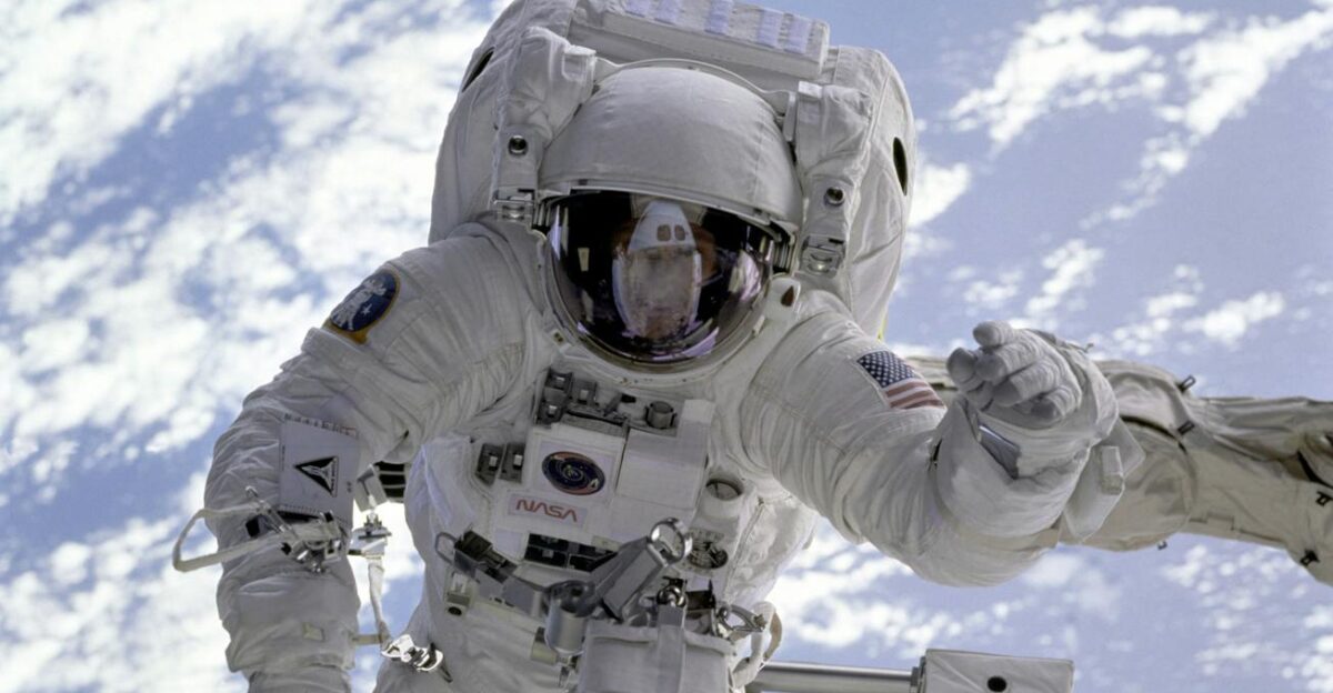 Astronaut conducting a spacewalk with Earth in the background showcasing outer space exploration