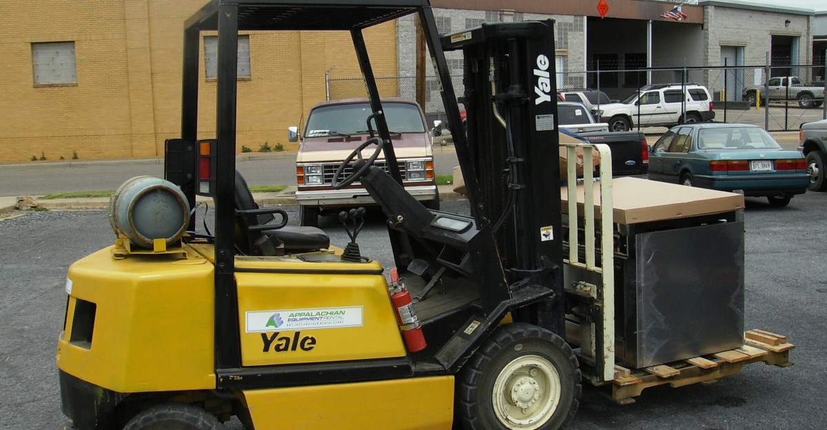 Yale forklift in parking lot of Our Community Place in Harrisonburg, Virginia loaded with kitchen equipment.