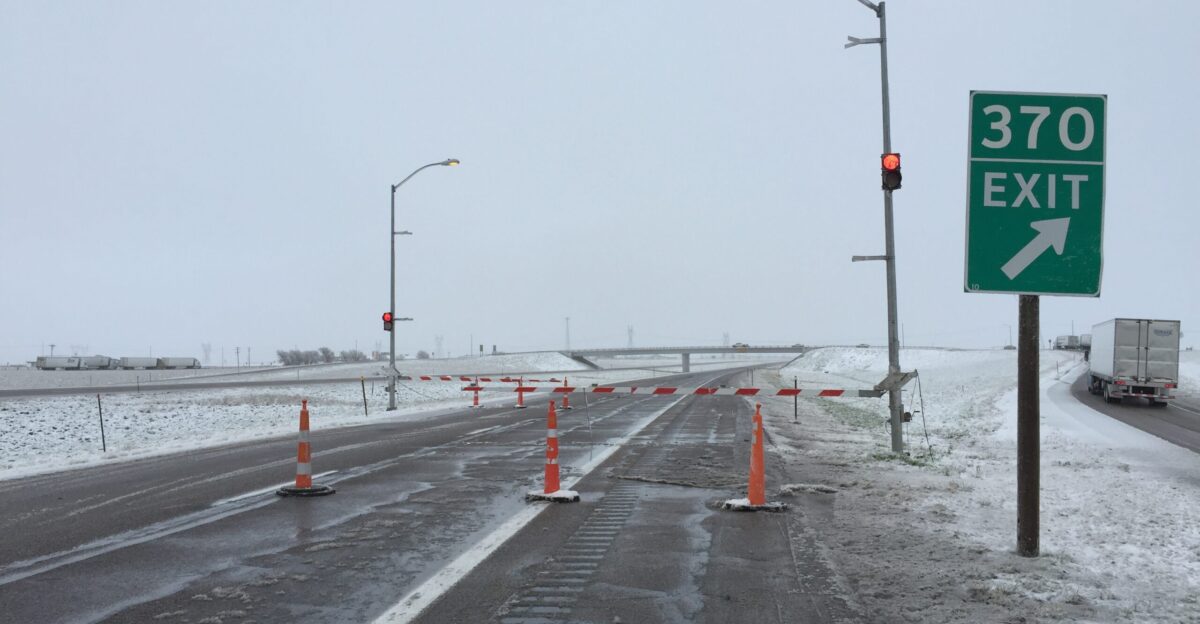 Gate and cones blocking the main lanes of Interstate 80 during a late spring snowstorm at Exit 370 in Archer Laramie County Wyoming