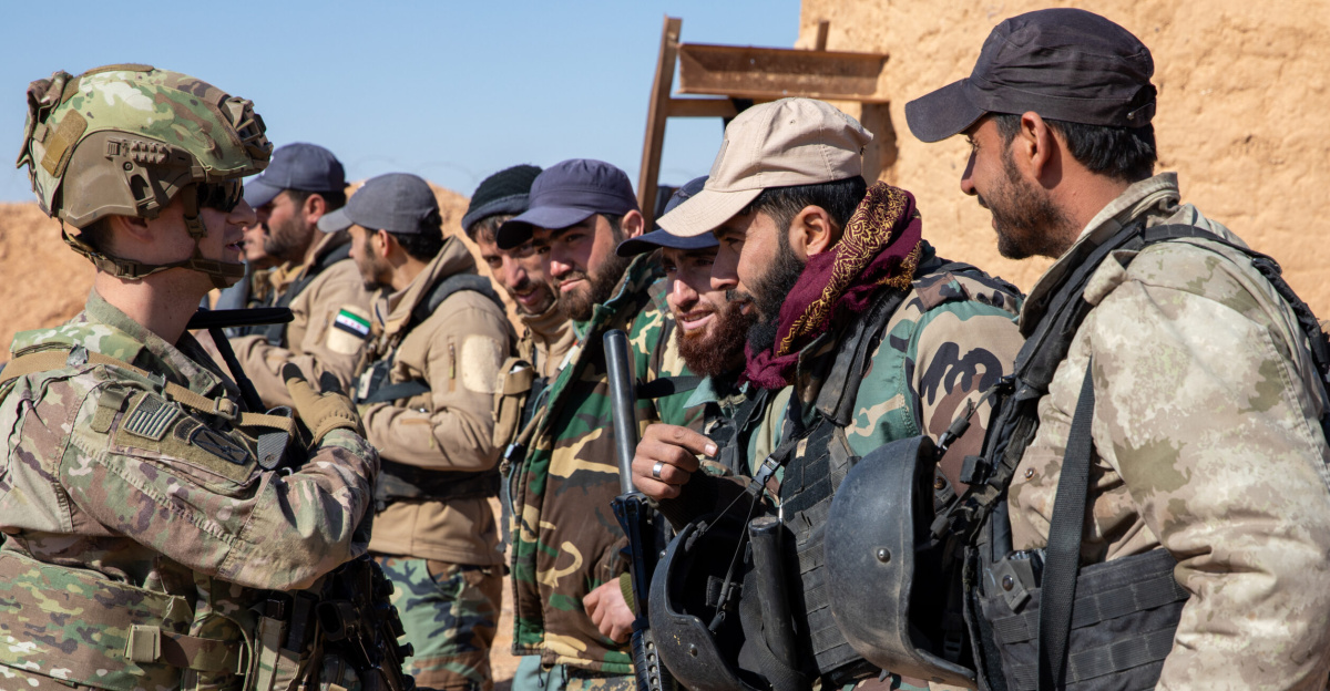 U.S. Army 2nd Lt. Zach Panici, a platoon leader assigned to 10th Mountain Division, Task Force Armadillo, speaks with Syrian Free Army (SFA) soldiers at a combat outpost in the Deconfliction Zone, Syria, Feb. 7, 2025. Coalition Forces assessed the outpostâs conditions and trained SFA soldiers on personnel and vehicle searches, as well as checkpoint operations. The Coalition remains committed to advising, assisting, and enabling partner forces to ensure ISIS remains defeated and to maintain regional security and stability. (U.S. Army photo by Staff Sgt. Fred Brown)