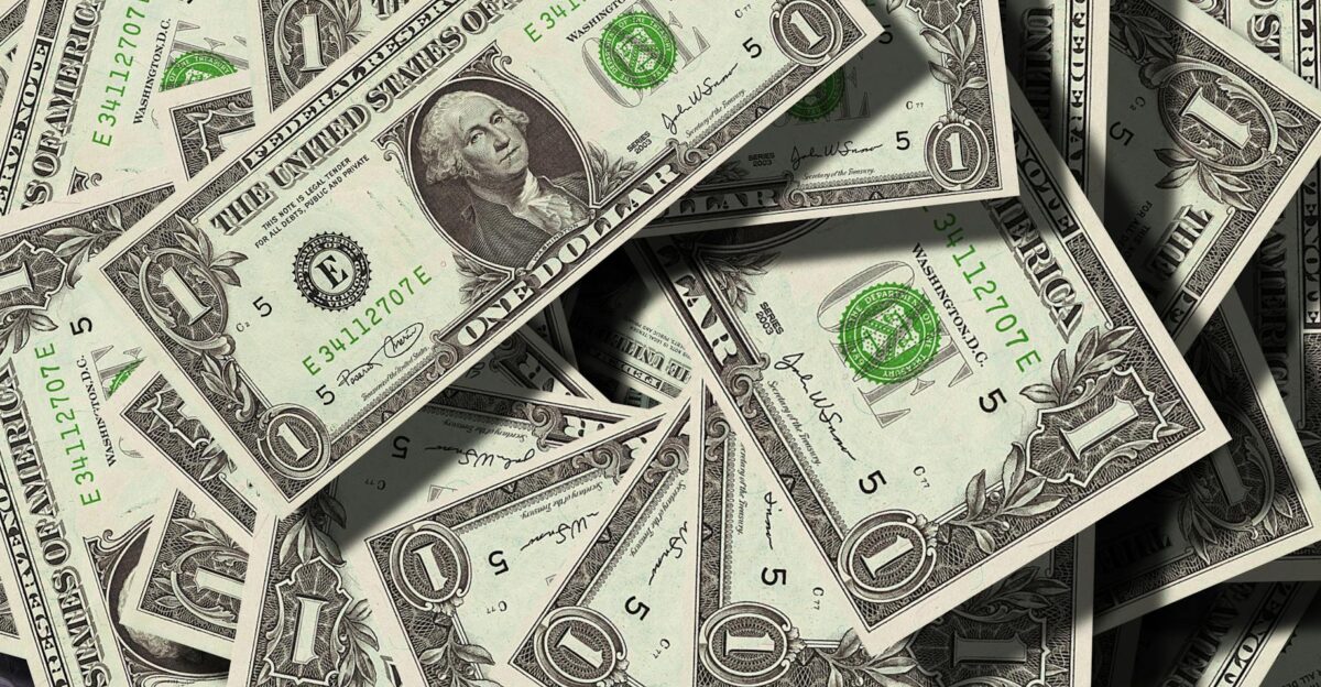 Close-up of scattered US dollar bills symbolizing finance and wealth