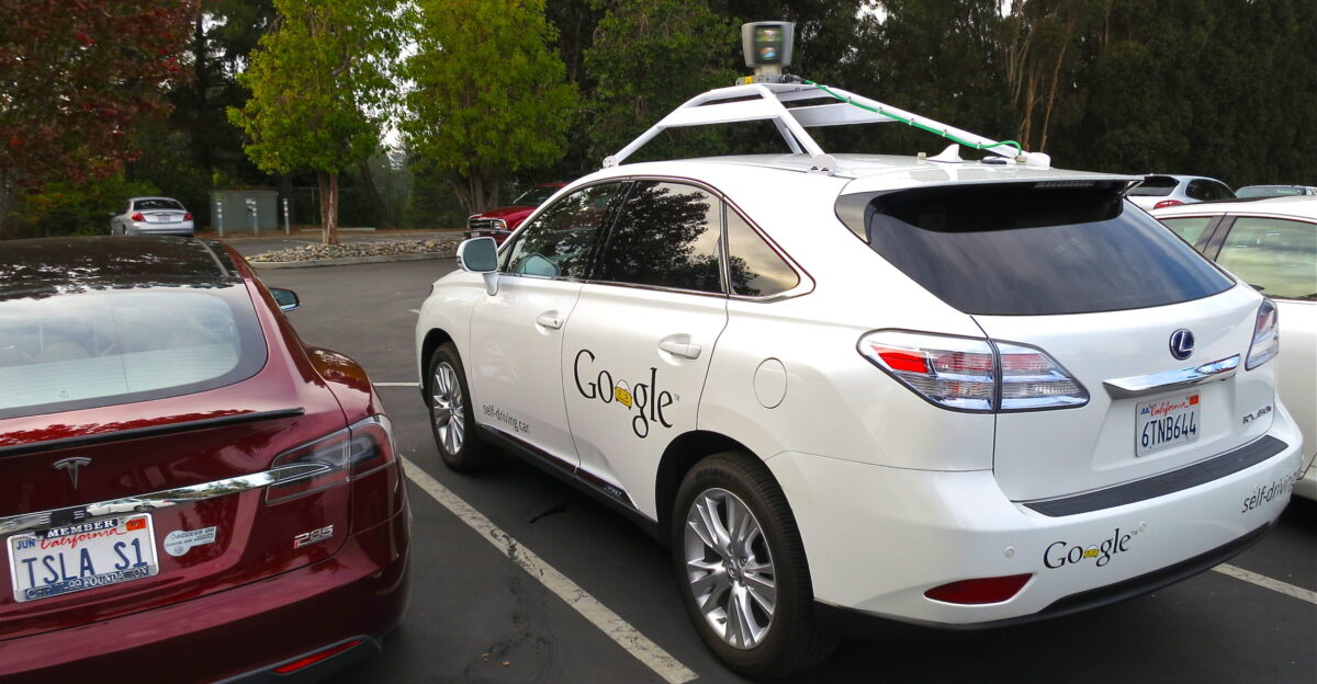Lexus RX450h retrofitted by Google for its driverless car fleet At the left side is parked a Tesla Model S electric car