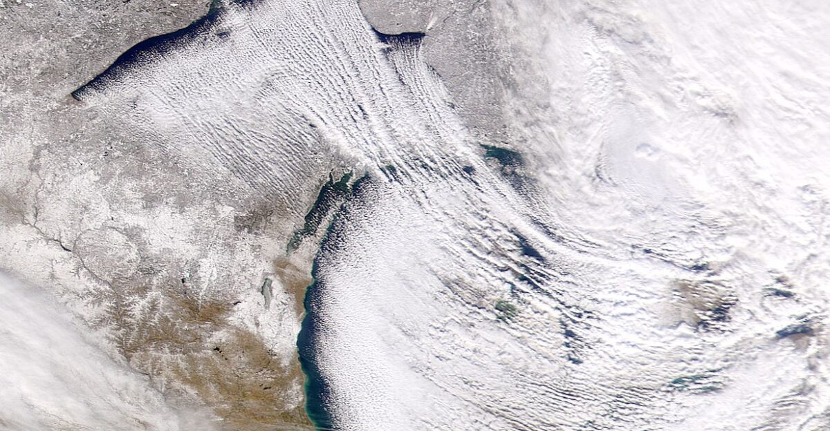On December 5 2000 SeaWiFS acquired this image of lake-effect snow occurring over the Great Lakes region Lake-effect snow occurs when cold dry air passes over a larger warmer lake and picks up moisture and heat Clouds build overhead and eventually develop into snow showers as they move downwind In this image the wind is seen to be moving from the north-west It picks up moisture from Lakes Nipigon Superior and Michigan and deposits this as snow further downwind