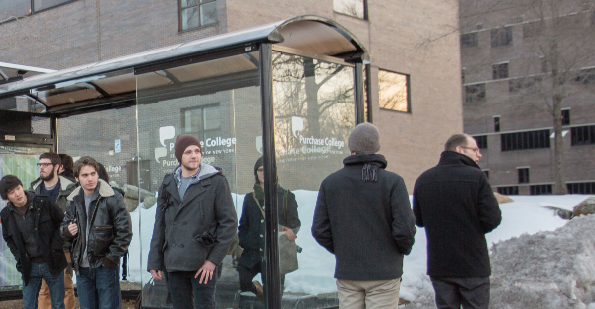 People waiting at bus stop in Purchase New York moments before the bus arrives