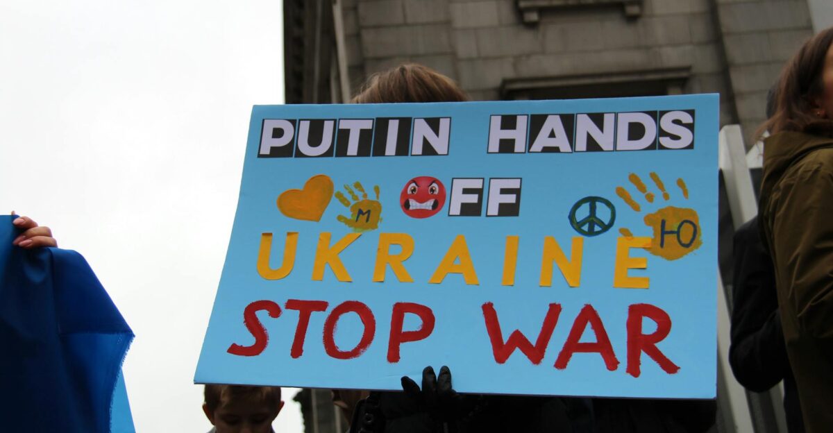 Protesters in Vancouver hold signs advocating peace and opposing war in Ukraine