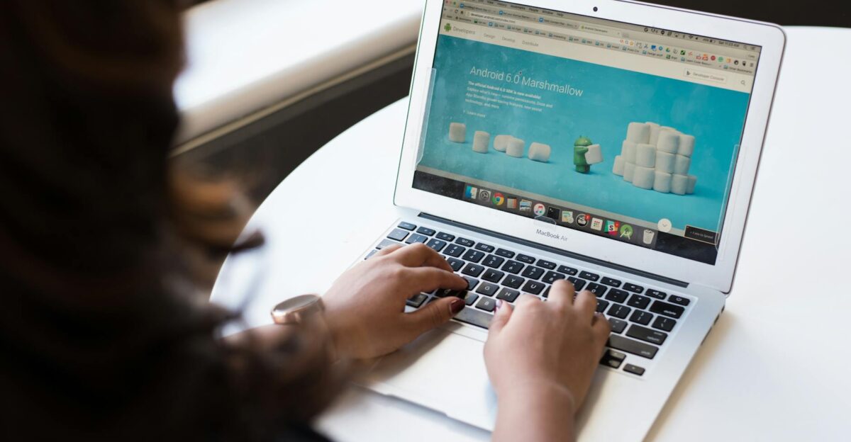 Businesswoman working on laptop with Android 6 0 Marshmallow webpage open