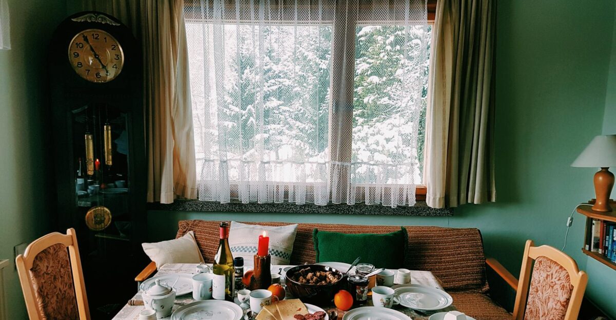 Warm and inviting dining room set for a festive meal with a snowy view outside
