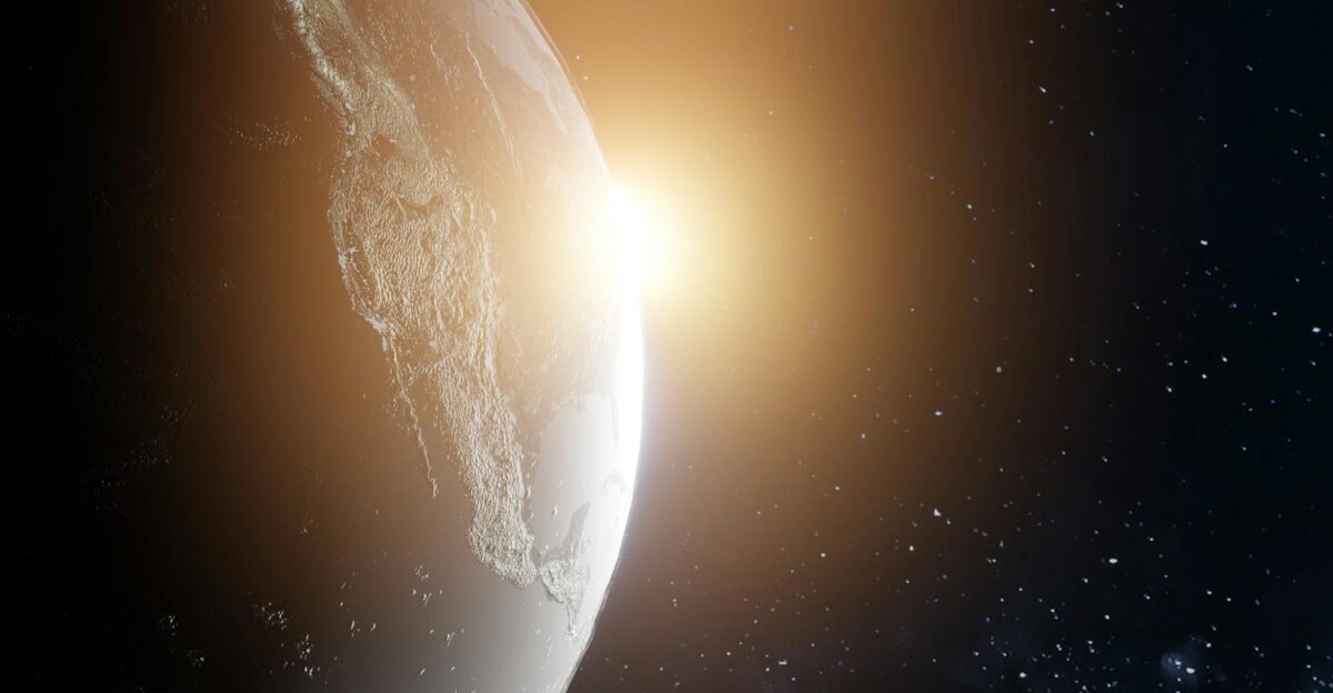 A breathtaking view of Earth with the sun rising illuminating the planet in space