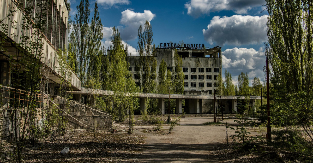 Deserted structure overgrown by nature in Chernobyl, Ukraine, reflecting post-disaster decay.