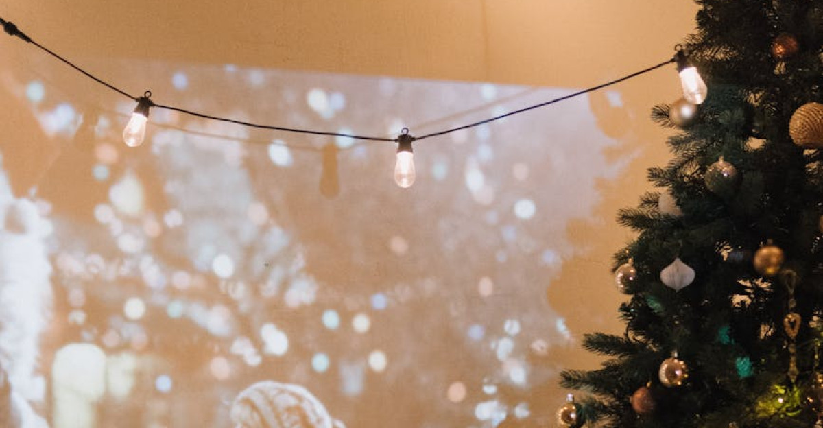 Couple enjoying a festive movie night with a Christmas tree and projector indoors