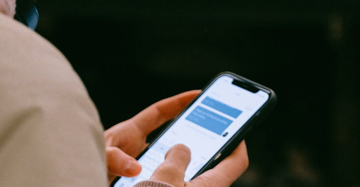 A person using a smartphone for texting focusing on their hands and device screen