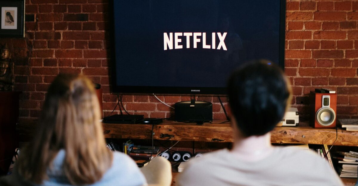 A couple relaxing and watching Netflix in a cozy living room setting