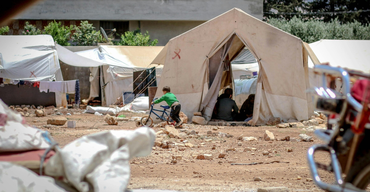 Temporary fabric tents located on ground with garbage in poor district for refugee camp