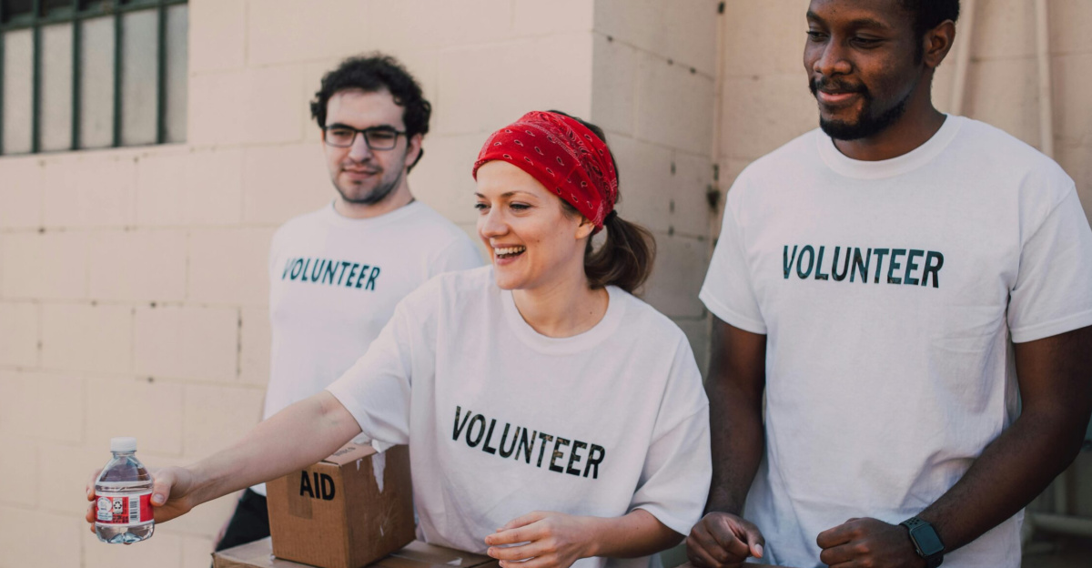 Volunteers distributing aid at an outdoor donation center, promoting social impact and diversity.