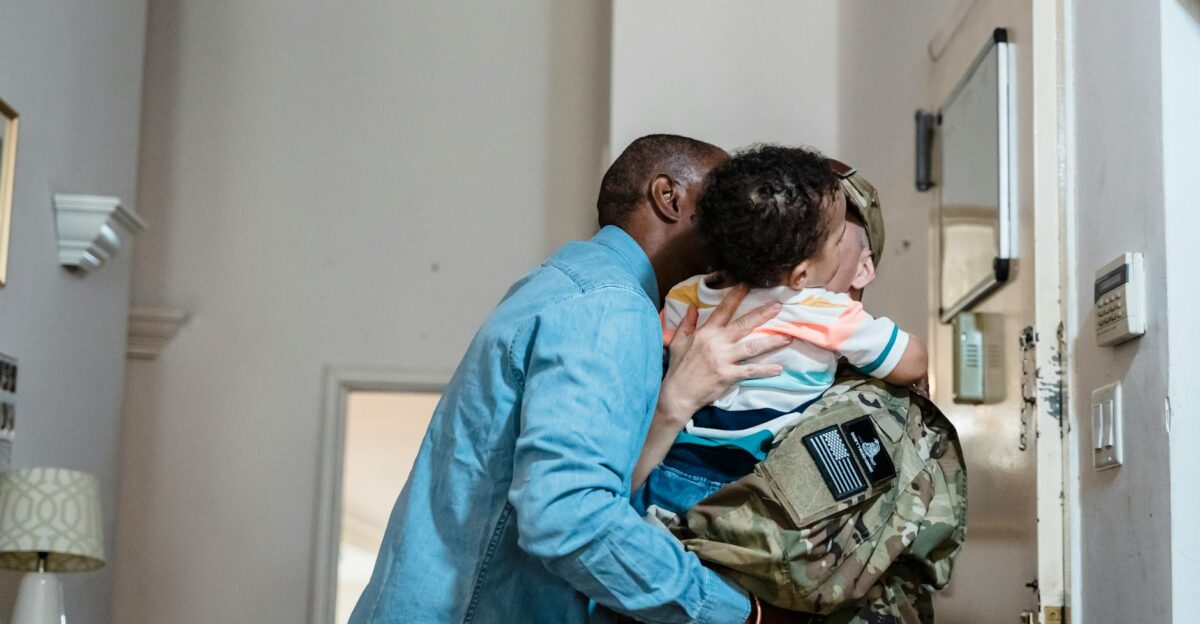 A touching reunion as a military parent arrives home embracing their child inside a cozy house