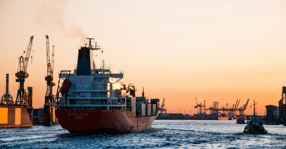 Stunning sunset view of cargo ships and cranes at the Port of Hamburg epitomizing global trade and logistics
