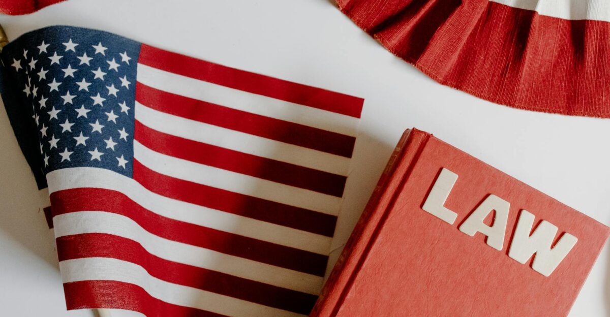 Patriotic scene with American flag and law book on a white background symbolizing freedom and democracy