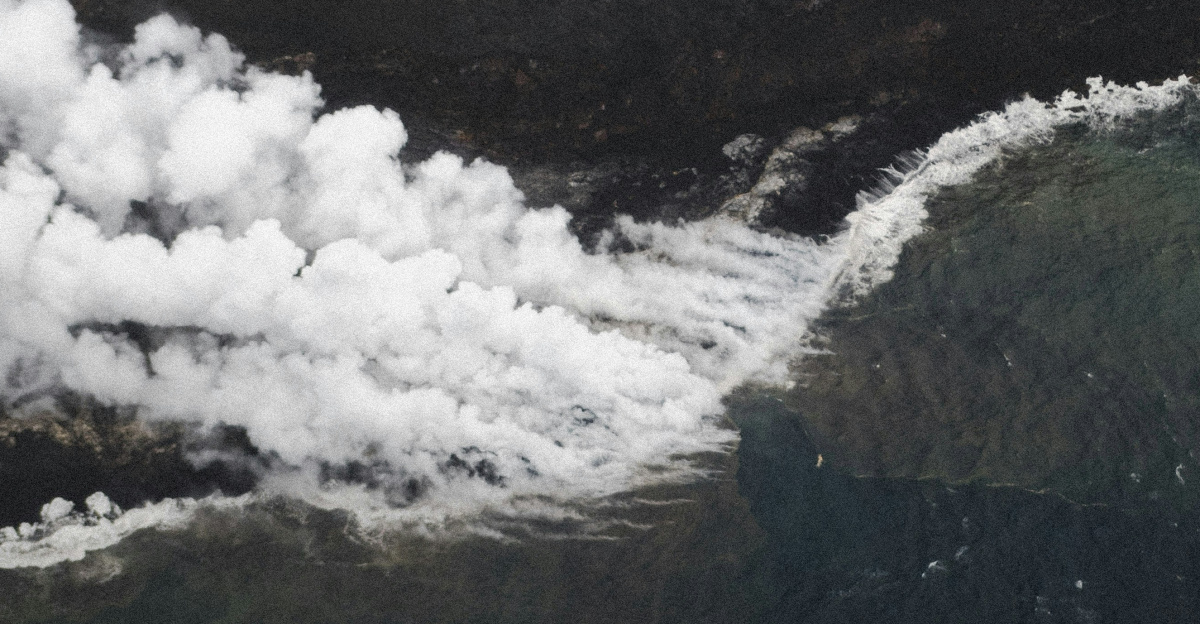 an aerial view of smoke coming out of the ocean