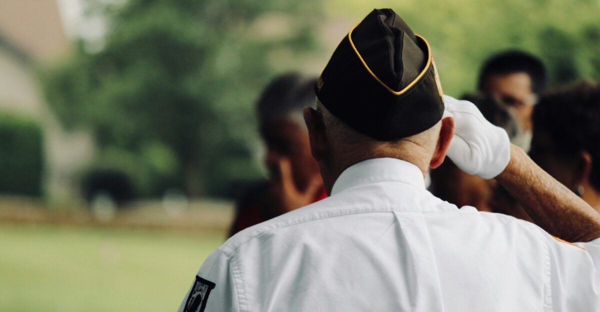 man wearing white uniform saluting