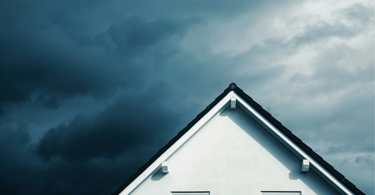 white wooden house under gray sky