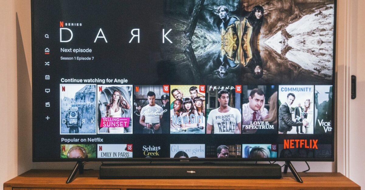 black flat screen tv turned on displaying man in black suit