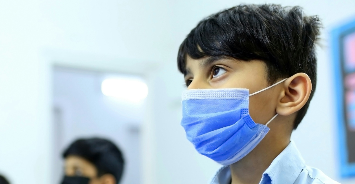 boy in white button up shirt wearing white face mask