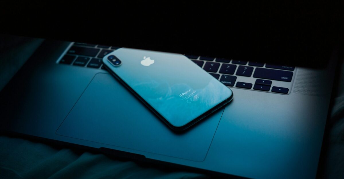 a laptop computer sitting on top of a bed