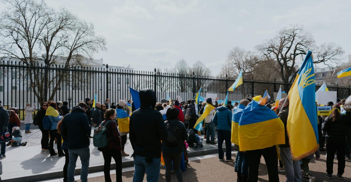 a group of people standing next to each other holding flags