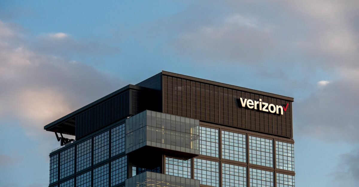 a very tall building with a verizon sign on top