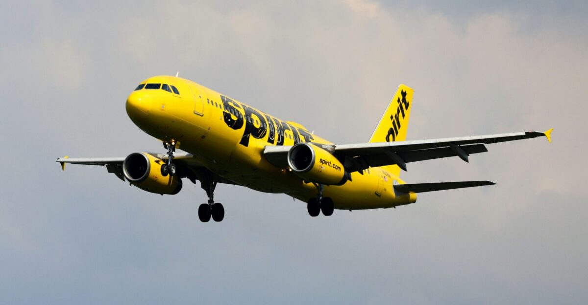 a yellow and black airplane flying