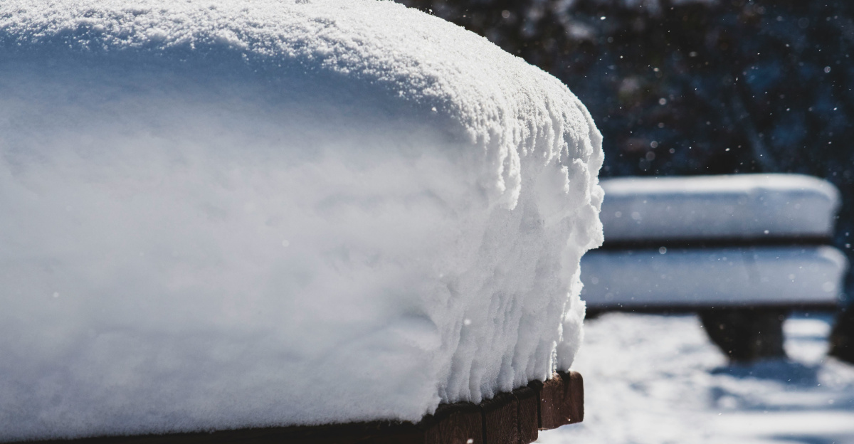 a bench covered in snow