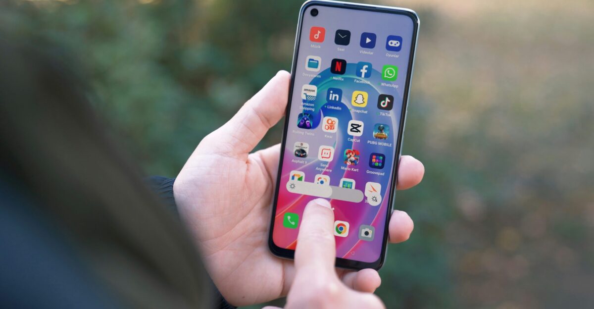 a person holding a cell phone in their hand