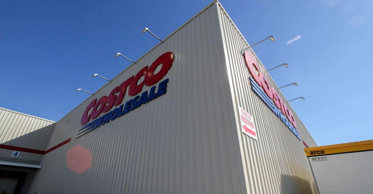 a large white building with a red and blue sign on it