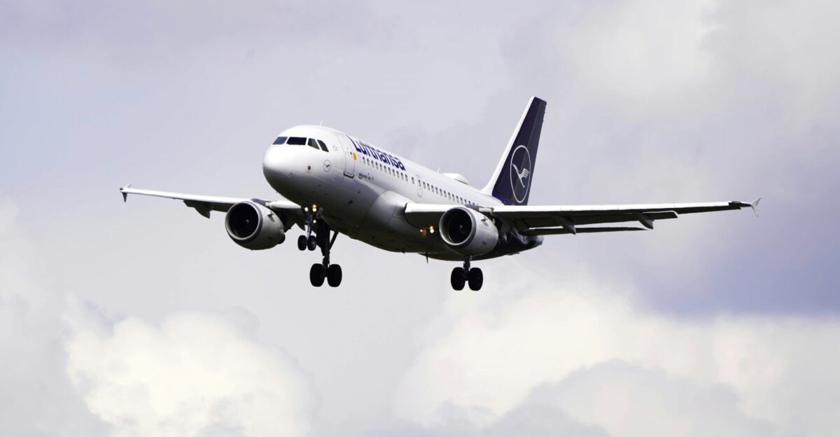a large jetliner flying through a cloudy sky