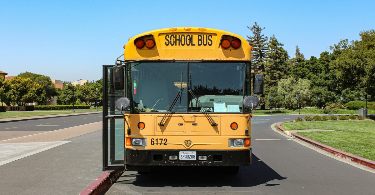 a yellow school bus driving down a street