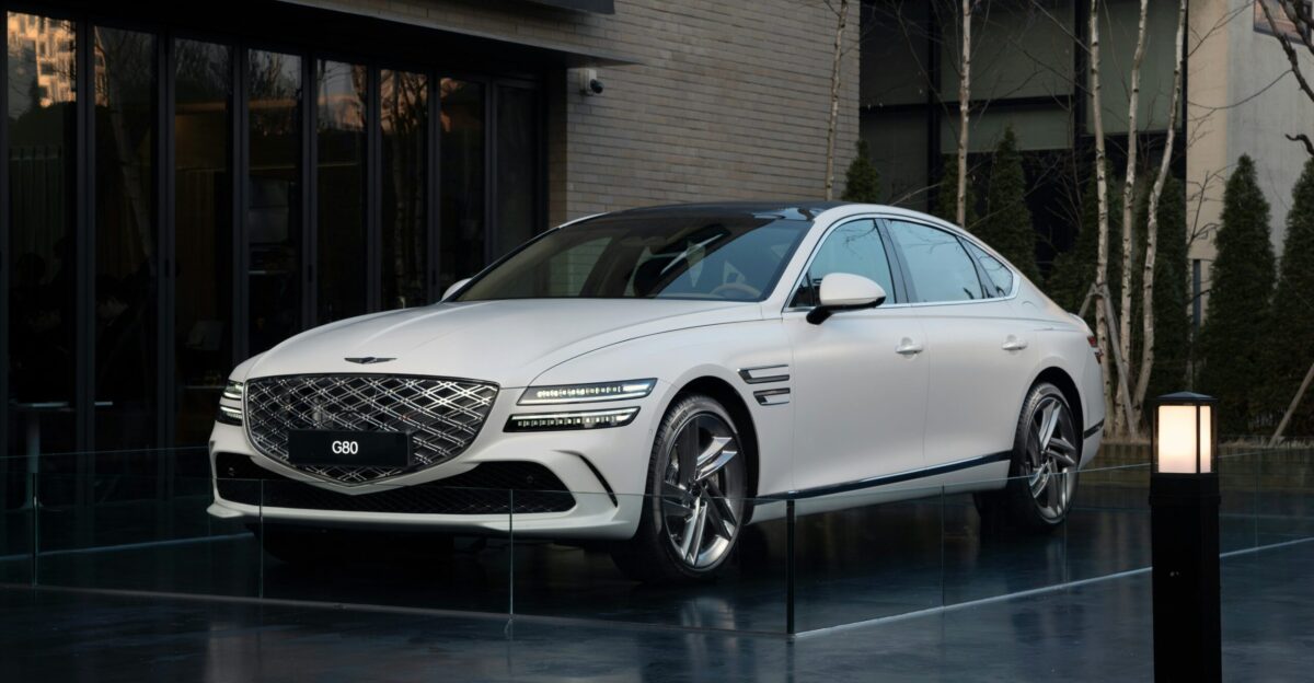 a white car parked in front of a building