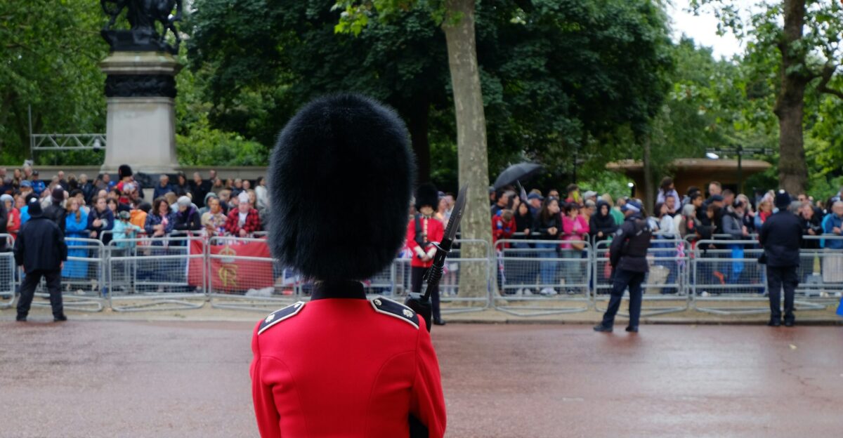 A man in a red uniform standing in front of a crowd