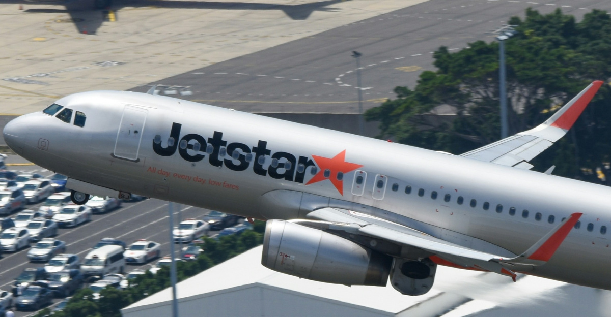 A jetliner taking off from an airport runway