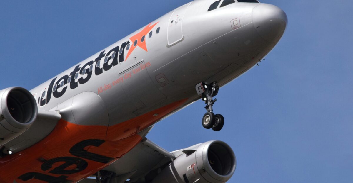 A large jetliner flying through a blue sky