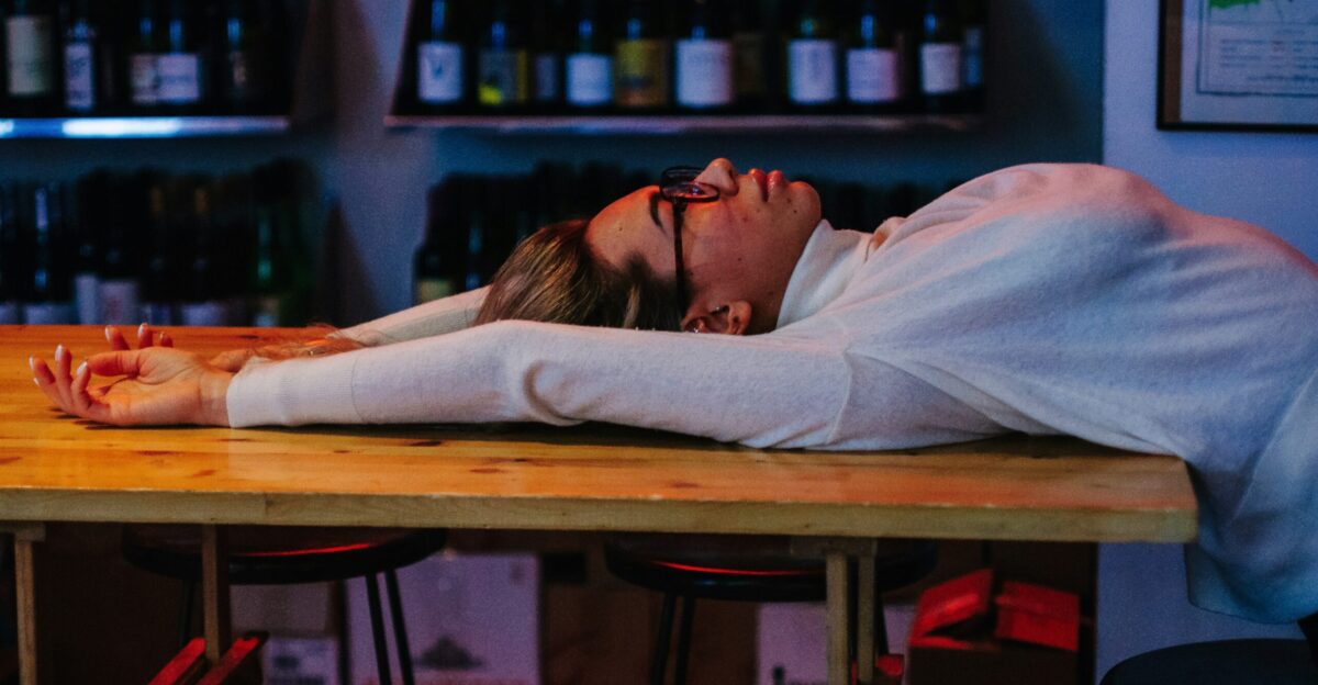 A woman laying on a table in a bar
