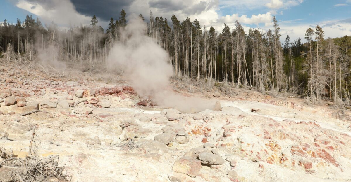 Steam rises from a geothermal landscape