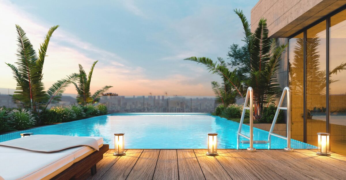 Rooftop swimming pool with lounge chair at sunset