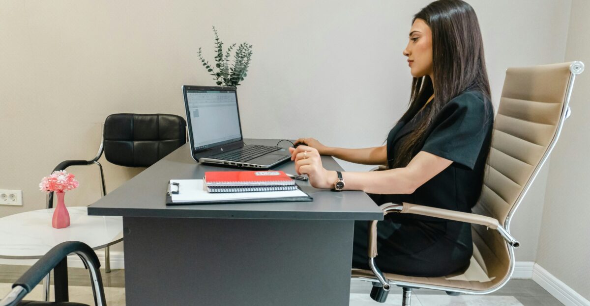 Woman working on laptop at office desk