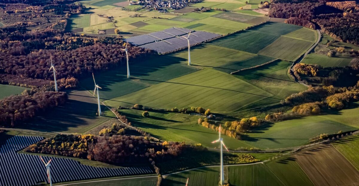 Wind turbines and solar panels in a rural landscape