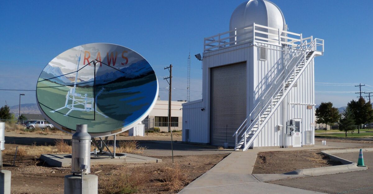 Remote Automated Weather Station satellite receiver These stations strategically located throughout the U S monitor the weather and provide data that assists land management agencies with a variety of projects such as monitoring air quality rating fire danger and providing information for research applications In the background to the right is the Boise Idaho National Weather Service Office s Upper Air shelter where weather balloons are released The Boise National Weather Service Office and National Interagency Fire Center are co-located at Boise Airport
