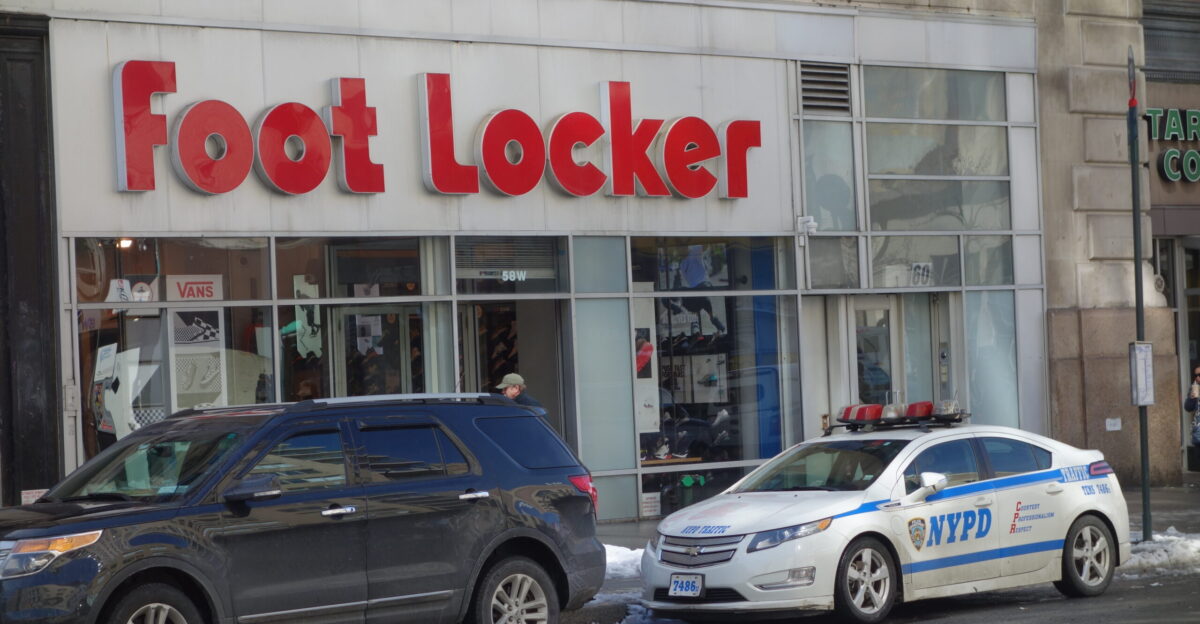 The Foot Locker 58 West 14th Street at the southeast corner of 14th Street and 6th Avenue in Chelsea Greenwich Village Manhattan In the foreground is a Chevrolet Volt cruiser of the NYPD