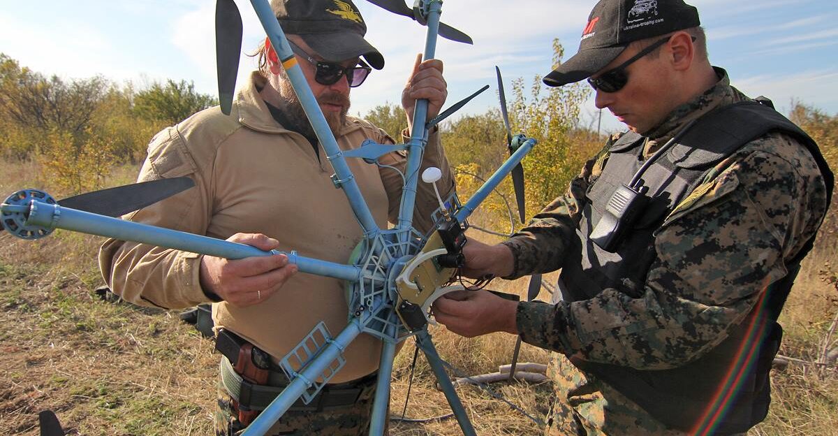 Volodymyr Kochetkov-Sukach and Yaroslav Honchar are holding the prototype of R18 octocopter developed by Aerorozvidka