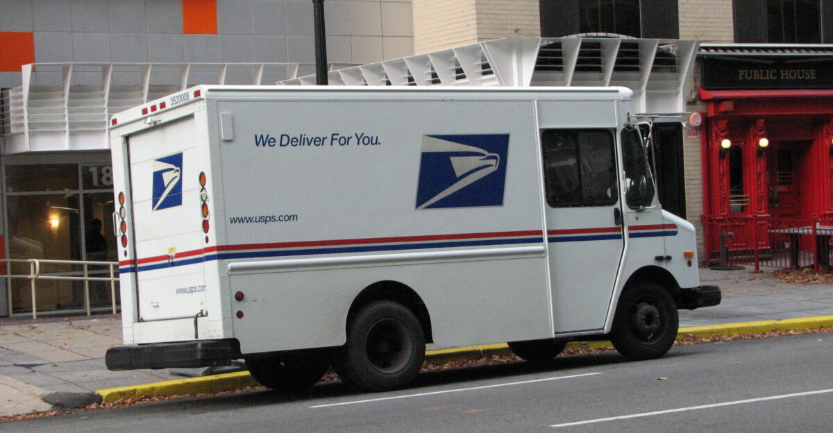 A United States Postal Service delivery truck parked in front of The Quincy hotel on L Street NW in Washington D C