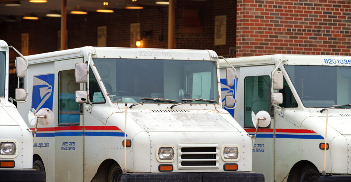 United States Postal Service USPS mail delivery trucks outside the U S Post Office in Hays Kansas
