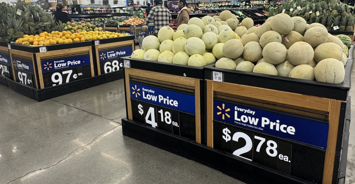Produce section of a Walmart store with bins of melons, pineapples, and other fruit under “Everyday Low Price” signs. Napa, California.